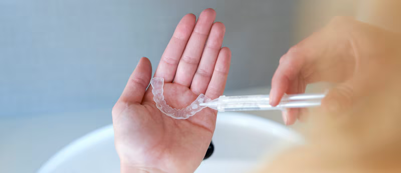 Lady preparing her teeth whitening kit